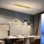 Modern gold linear pendant chandelier (FBCD-048) featuring geometric LED rings, cylindrical spotlights, and a black base, projecting a star pattern.