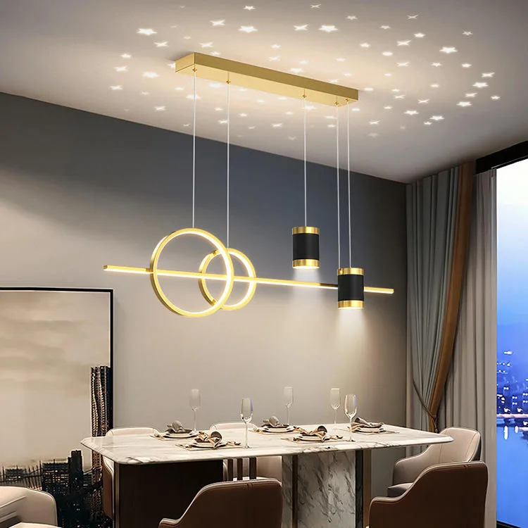 Modern gold linear pendant chandelier (FBCD-048) featuring geometric LED rings, cylindrical spotlights, and a black base, projecting a star pattern.